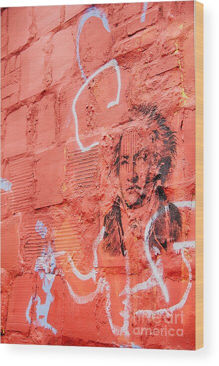 Etched Man On A Red Brick Wall Wood Print featuring the photograph Etched man on a red brick wall by Jim Lepard