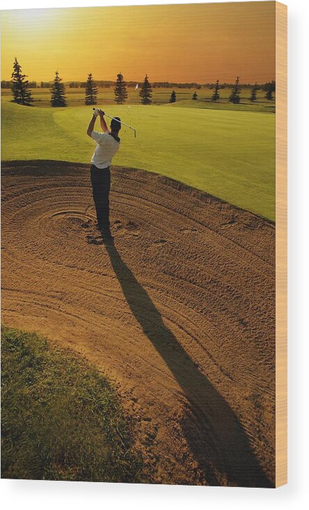 Twilight Wood Print featuring the photograph Golfer Taking A Swing From A Golf Bunker by Darren Greenwood