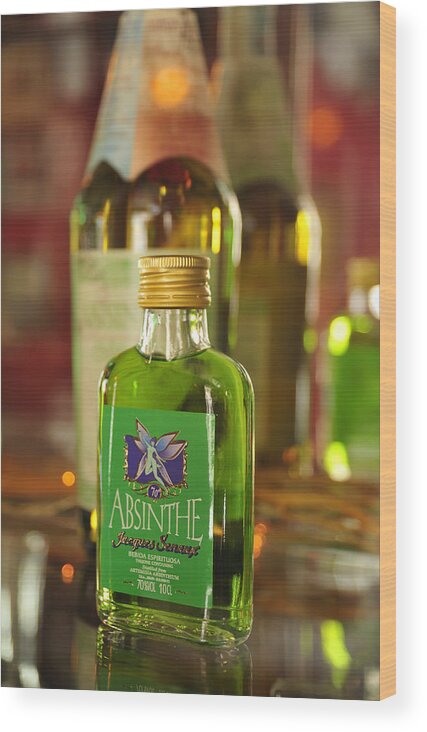 Absinthe Wood Print featuring the photograph Green Absinthe in small bottle by Matthias Hauser