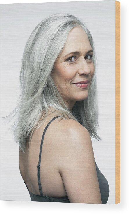 Looking Over Shoulder Wood Print featuring the photograph Mature woman with grey hair in a 3/4 position. by Andreas Kuehn