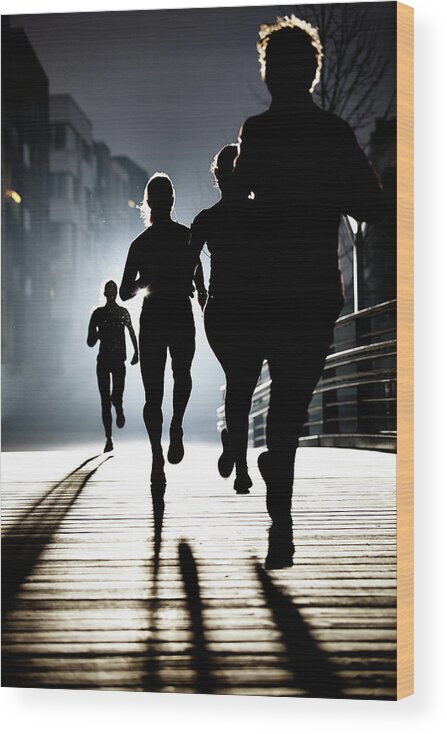 People Wood Print featuring the photograph Small Group Of Runners By Night by Henrik Sorensen