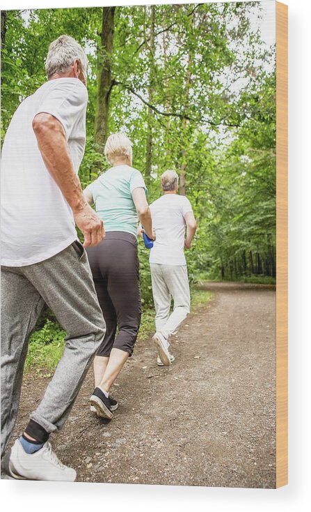 Three People Wood Print featuring the photograph Three People Running On Track In Woods by Science Photo Library