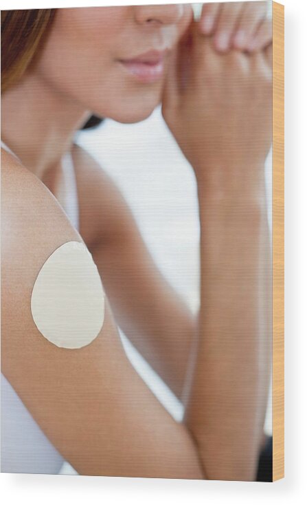 25-29 Years Wood Print featuring the photograph Young Woman Wearing Nicotine Patch by Science Photo Library