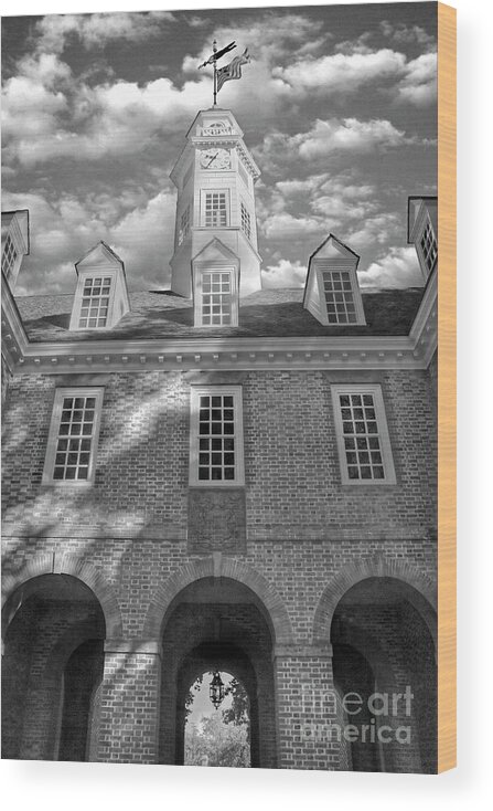 Colonial Williamsburg Capital Building Autumn Fall Leaves Color Morning Duke Of Gloucester Street Virginia Clouds Blue Sky Flag Black And White Wood Print featuring the photograph Capital Colonial Williamsburg B and W by Karen Jorstad