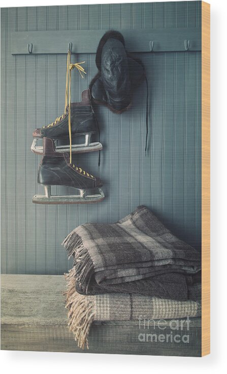 Aging Wood Print featuring the photograph Men's vintage skates and hat hanging on hook by Sandra Cunningham