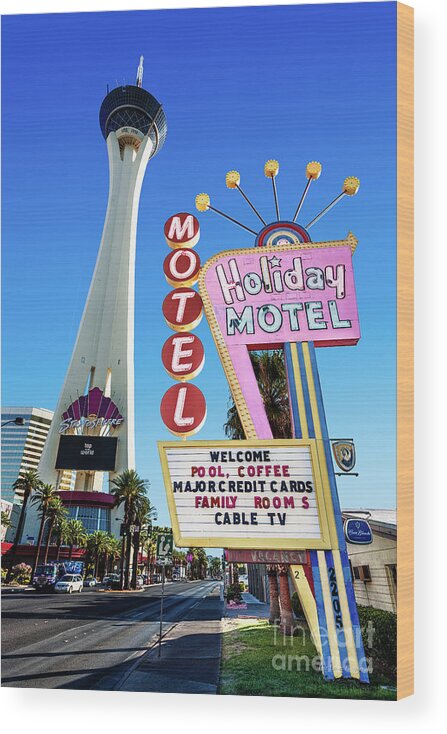The Stratosphere Wood Print featuring the photograph The Stratosphere Casino in Front of the Holiday Motel Sign by Aloha Art