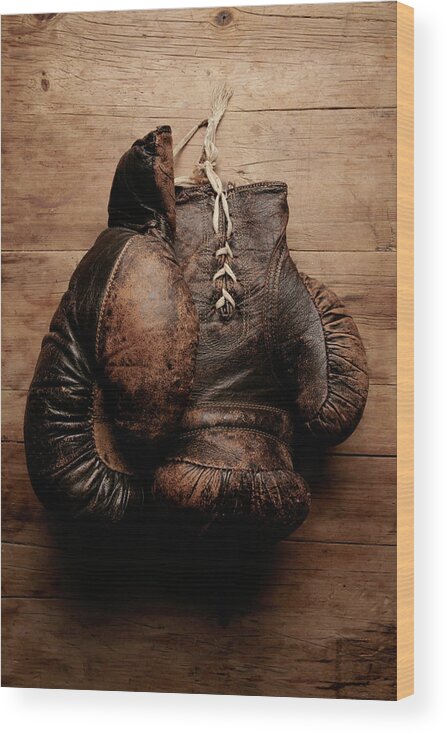 Hanging Wood Print featuring the photograph A Pair Of Worn Old Boxing Gloves On by The flying dutchman