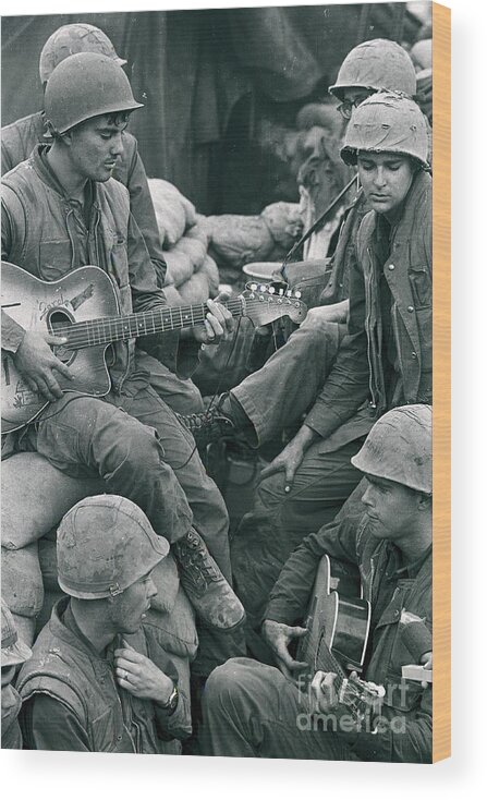 Vietnam War Wood Print featuring the photograph Marine Soldier Playing Guitar To Buddies by Bettmann