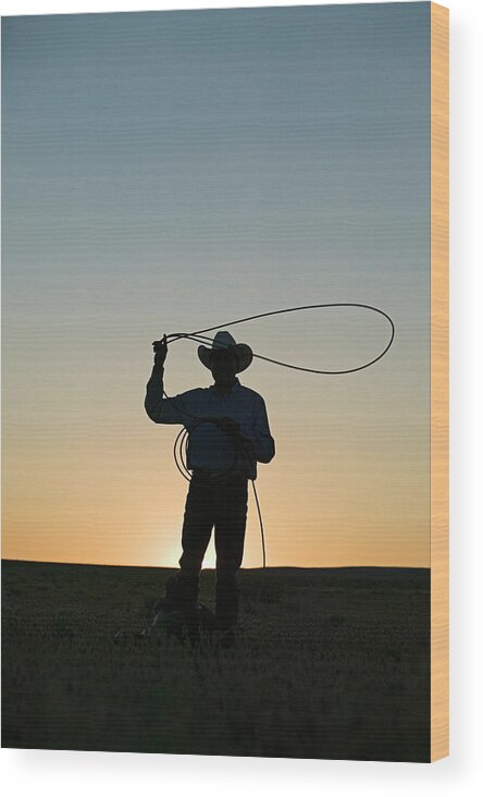 Dawn Wood Print featuring the photograph Silhouette Of Cowboy With Lasso by Edward Mccain