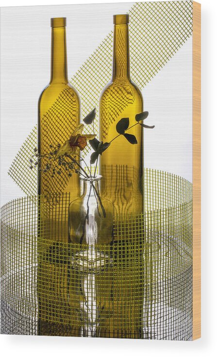 Still Life Wood Print featuring the photograph Still Life With Glass Bottles, Flowers And Yellow Mesh by Brig Barkow
