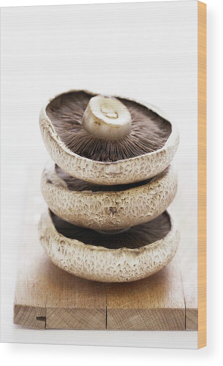 White Background Wood Print featuring the photograph Three Flat Mushrooms In Pile On Wooden by Martin Poole