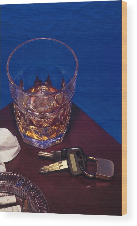 Punishment Wood Print featuring the photograph Alcoholic beverage next to car keys symbolizes drunk driving by Comstock