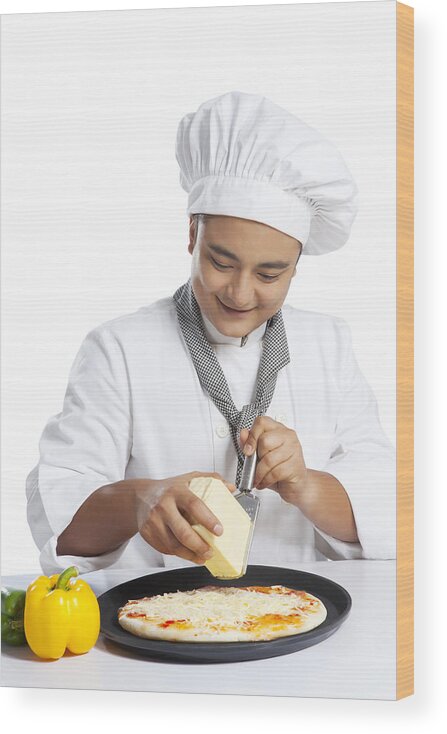 Expertise Wood Print featuring the photograph Chef grating cheese on pizza by Ravi Ranjan