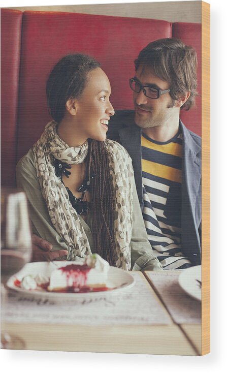 Young Men Wood Print featuring the photograph Couple eating dessert in cafe by Lumina Images