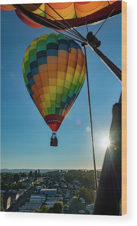 Hot Air Balloon Wood Print featuring the photograph Flying hot air balloon with sunburst by Dan Friend