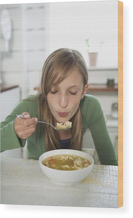 Shadow Wood Print featuring the photograph Girl eating chicken noodle soup by Fancy/Veer/Corbis