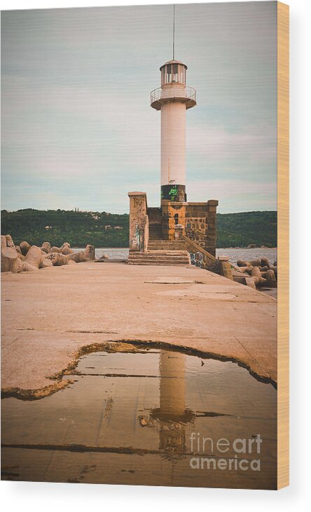 Lighthouse Wood Print featuring the photograph Lighthouse in the water at cloudy sunset by Yavor Mihaylov