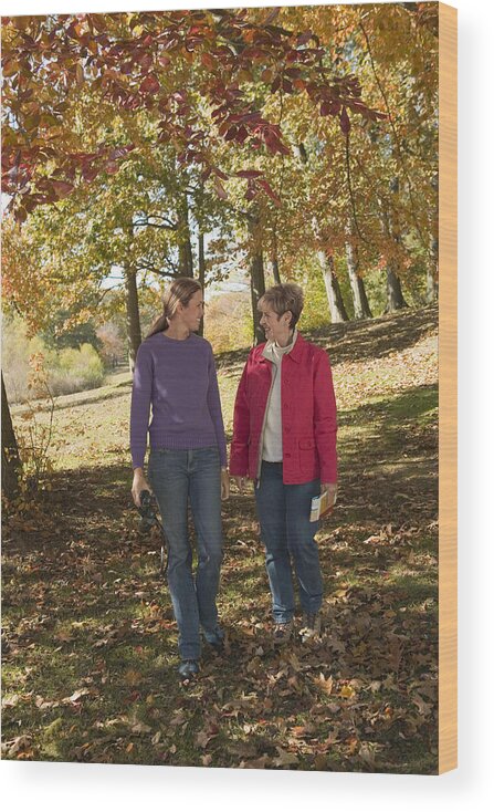 Season Wood Print featuring the photograph Mother and adult daughter walking outdoor by Comstock Images