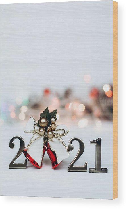 Event Wood Print featuring the photograph Numbers 2021 and bright christmas bell with gold ribbon by Olena Ruban