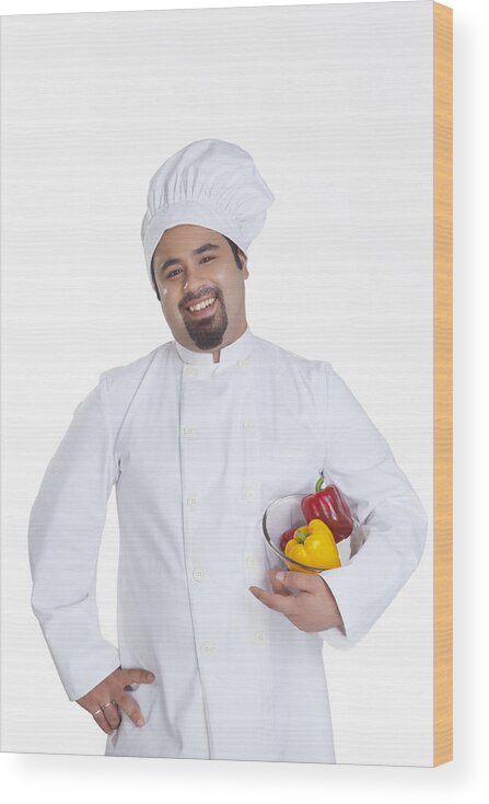 Young Men Wood Print featuring the photograph Portrait of chef with bowl of capsicum by Ravi Ranjan