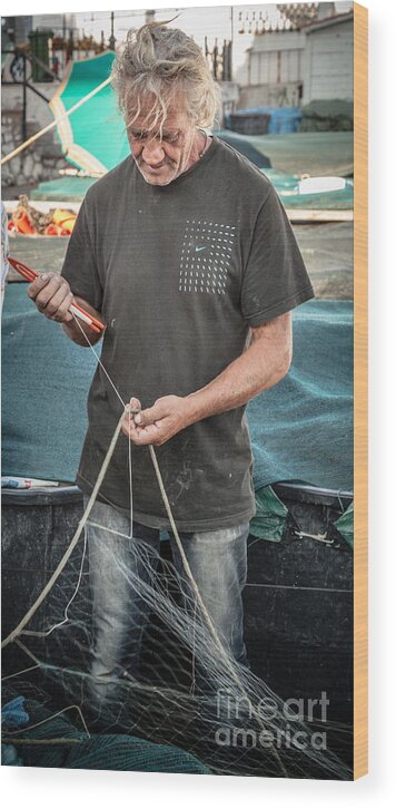 Anzio Wood Print featuring the photograph fisherman mending nets on Anzio harbour by Peter Noyce