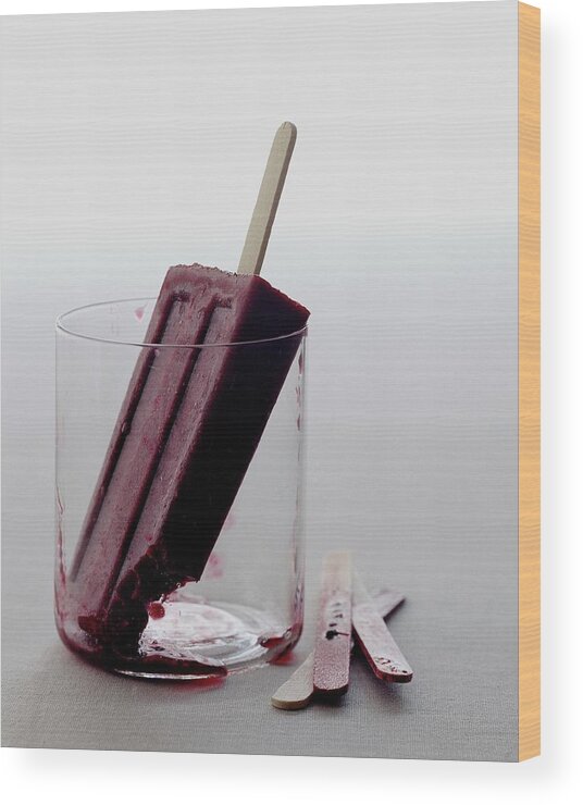 Snack Wood Print featuring the photograph A Blueberry Lime Popsicle by Romulo Yanes