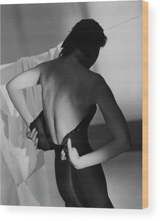 Fashion Wood Print featuring the photograph A Model Fastening Her Brassiere by Horst P. Horst