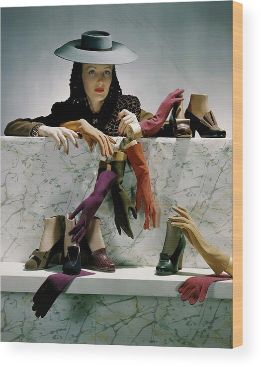 Accessories Wood Print featuring the photograph A Model Next To A Shelf Of Assorted Shoes by Horst P. Horst