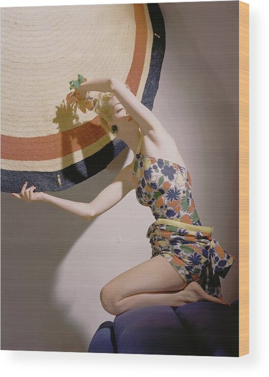 Fashion Wood Print featuring the photograph A Model Wearing A Swimsuit And Holding An by Horst P. Horst
