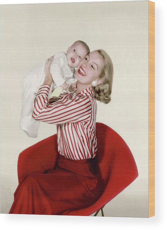 Fashion Wood Print featuring the photograph Dina Merrill Holding A Baby by John Rawlings