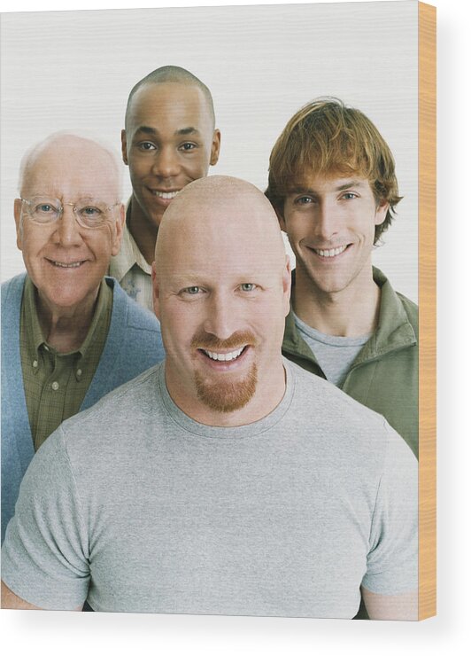 Young Men Wood Print featuring the photograph Studio Portrait of Four Smiling Men of Mixed Ages by Digital Vision.