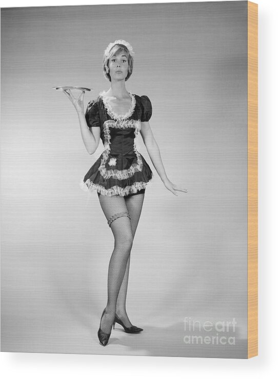 1960s Wood Print featuring the photograph Woman In French Maid Outfit, C.1960s by H. Armstrong Roberts/ClassicStock