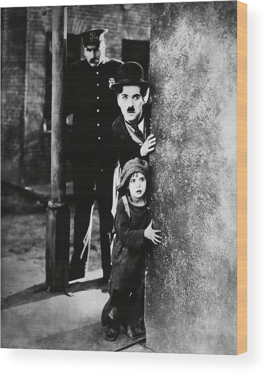 Charles Chaplin Wood Print featuring the photograph CHARLIE CHAPLIN and JACKIE COOGAN in THE KID -1921-. #1 by Album