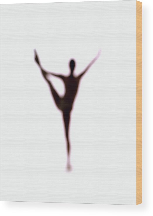 Ballet Dancer Wood Print featuring the photograph Silhouette Of Woman Balancing On One Leg #1 by John Slater