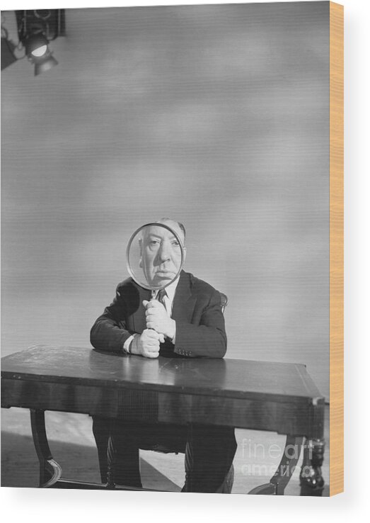 Mature Adult Wood Print featuring the photograph Alfred Hitchcock Holding Magnifying by Bettmann