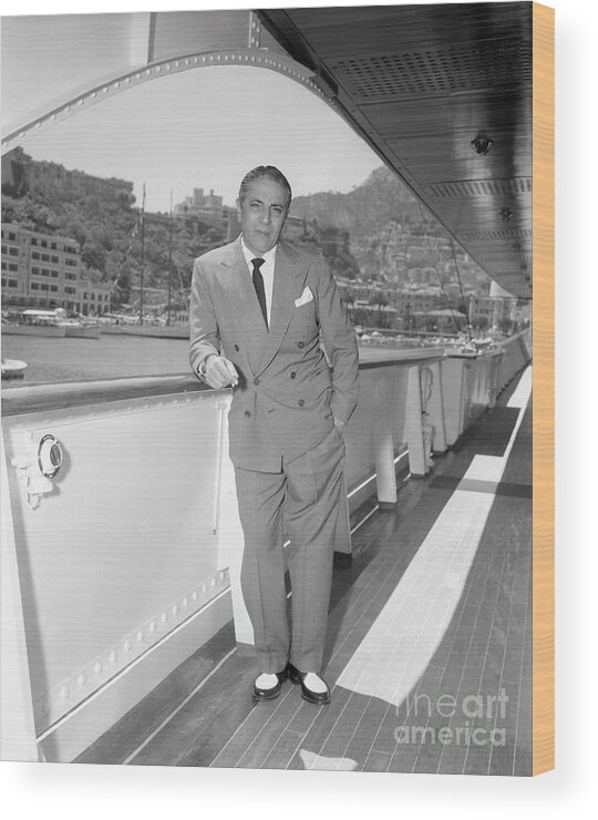 Mature Adult Wood Print featuring the photograph Aristotle Onassis Leaning On Railing by Bettmann
