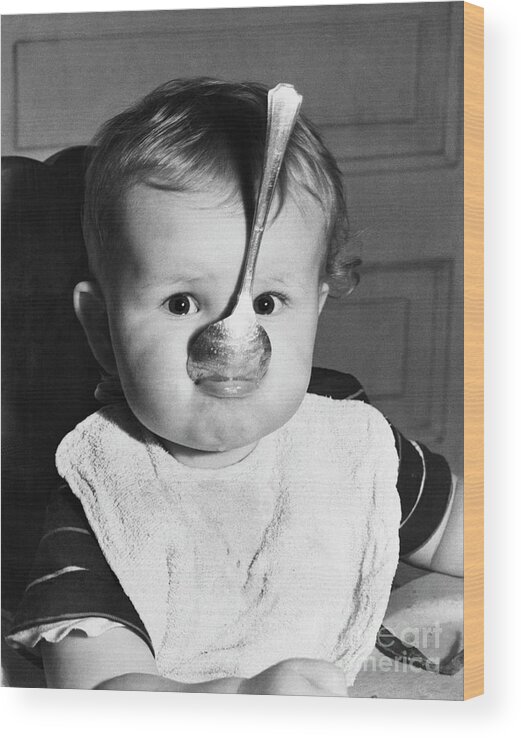 Child Wood Print featuring the photograph Baby With Spoon In Mouth by Bettmann