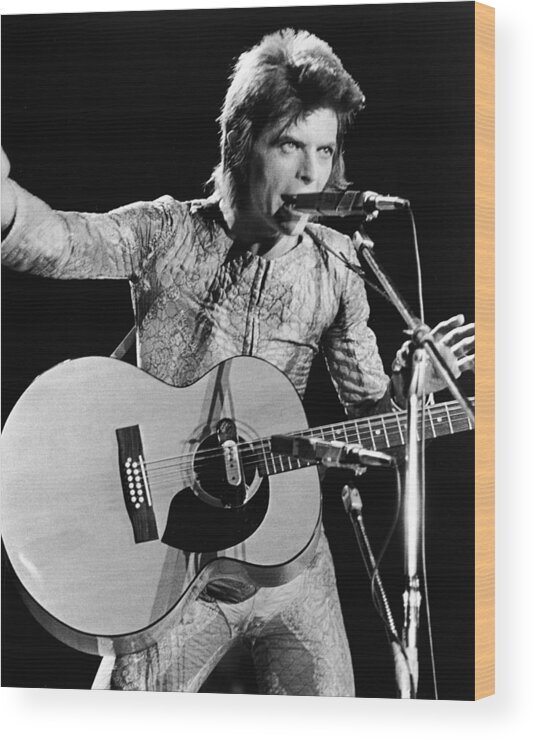 Ziggy Stardust - Persona Wood Print featuring the photograph David Bowie Performing As Ziggy Stardust by Hulton Archive Ziggy Stardust - Persona Wood Print featuring the photograph David Bowie Performing As Ziggy Stardust by Hulton Archive