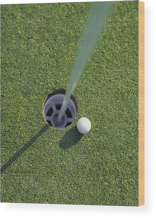 Outdoors Wood Print featuring the photograph Golf Ball Next To Hole On Golf Course by Peter Gridley