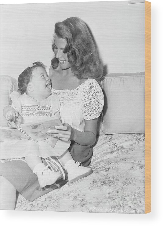 Mid Adult Women Wood Print featuring the photograph Rita Hayworth Reading To Daughter by Bettmann