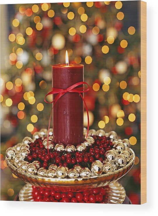 Christmas Ornament Wood Print featuring the photograph Candle placed in the center of some sweets arranged in a bowl by Michel Arnaud