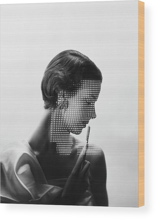 Fashion Wood Print featuring the photograph Model With Points of Lights Reflecting Across Her Face by Erwin Blumenfeld