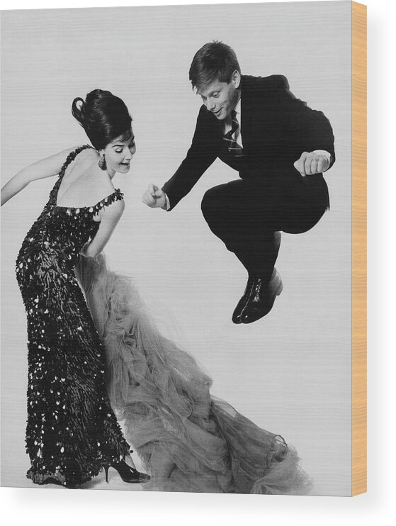 Actor Wood Print featuring the photograph Robert Morse Jumping Over Donna Sanders's Gown by Bert Stern