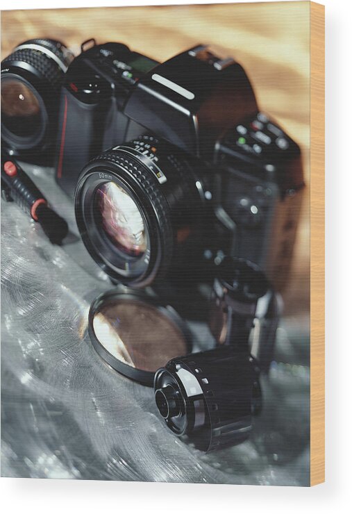 Camera Film Wood Print featuring the photograph Camera, lenses, and film canister by Stockbyte