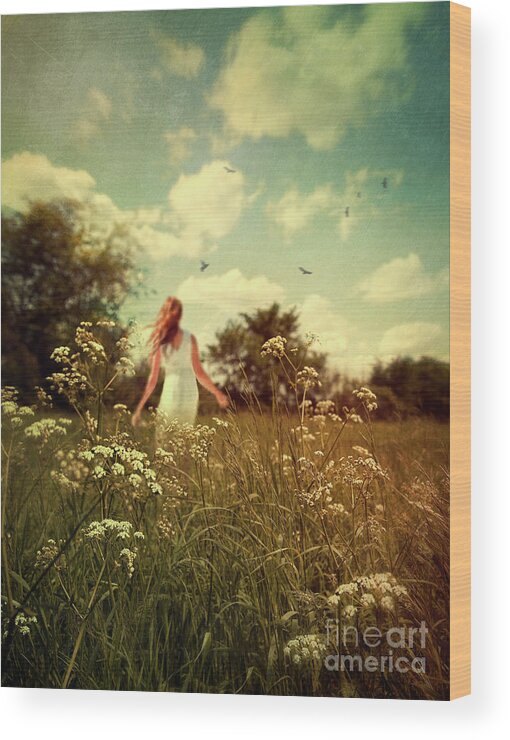 Alone Wood Print featuring the photograph Young girl walking in field of flowers #1 by Sandra Cunningham