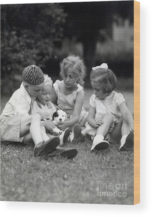 Child Wood Print featuring the photograph Children Playing With Puppy by Bettmann