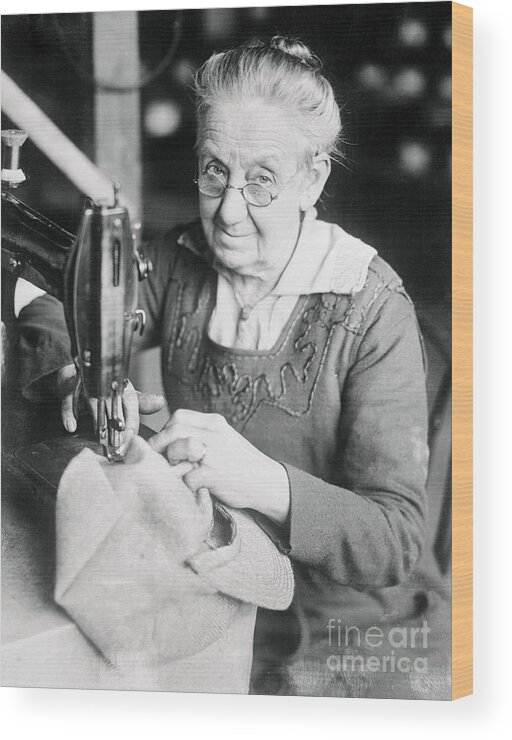 Working Wood Print featuring the photograph Woman Sewing A Cap by Bettmann