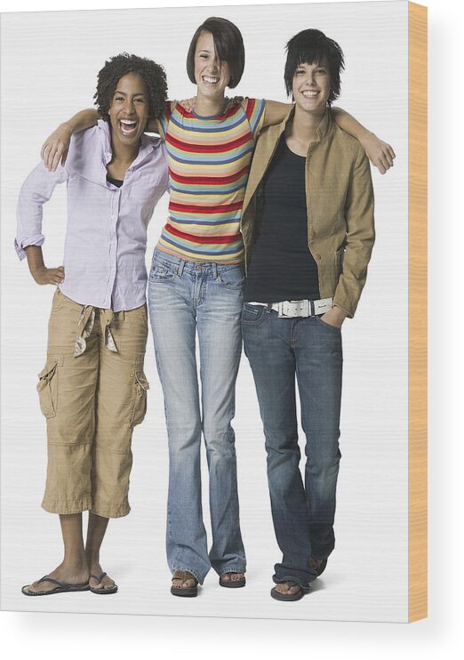 Cool Attitude Wood Print featuring the photograph Full Length Shot Of A Group Of Three Teenage Female Friends As They Smile At The Camera by Photodisc