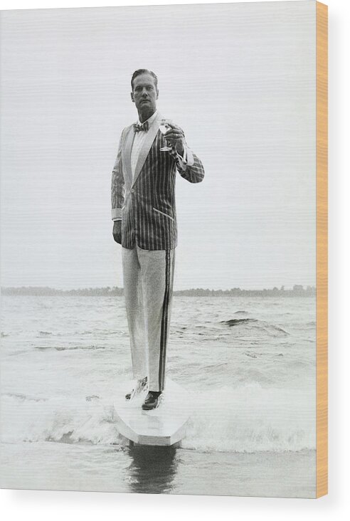 Menswear Wood Print featuring the photograph A Model Stands In The Surf In Bronzini by Richard Waite