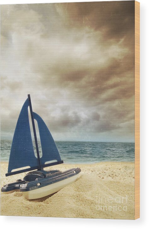 Beach Wood Print featuring the photograph Toy sailboat in the sand with vintage look by Sandra Cunningham